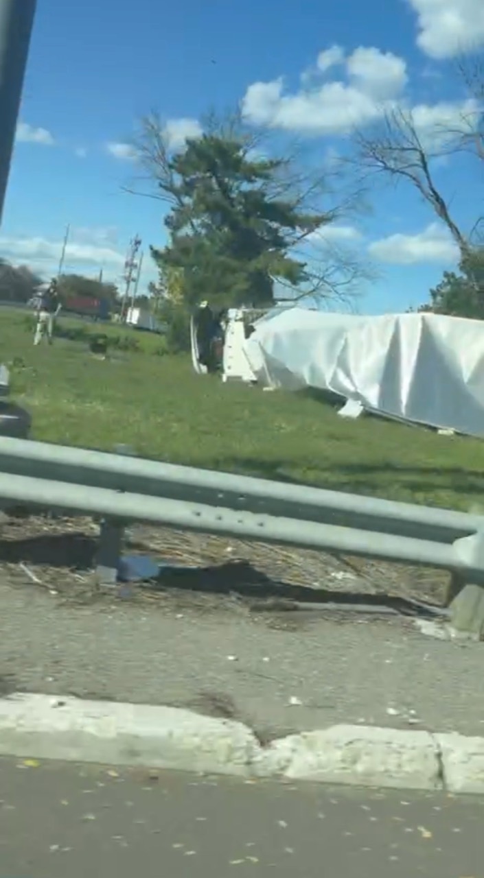 Frame from Jersey Alerts video showing an overturned white box truck beside a ramp near Paterson Plank Road in the Moonachie area on October 5, 2026.